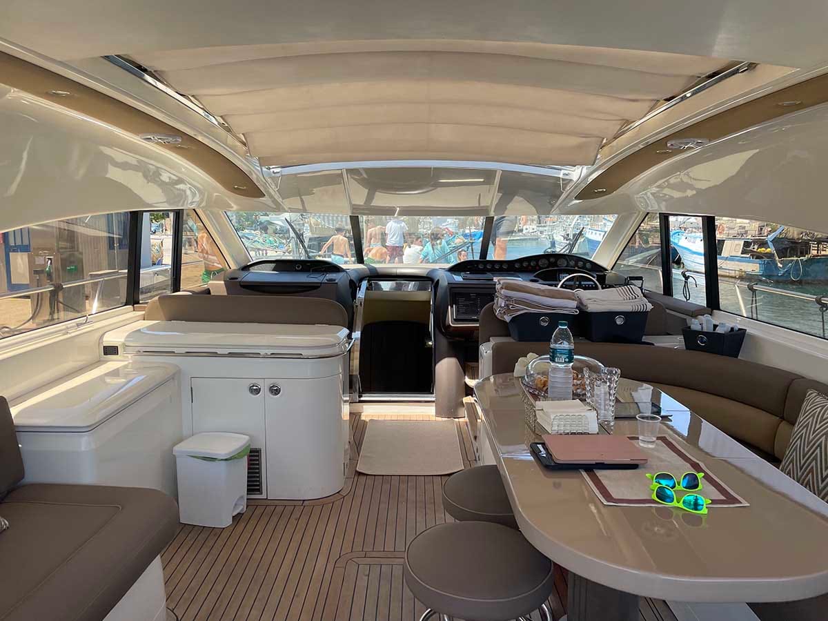 Salone interno del Princess V65 con dinette e postazione di guida.